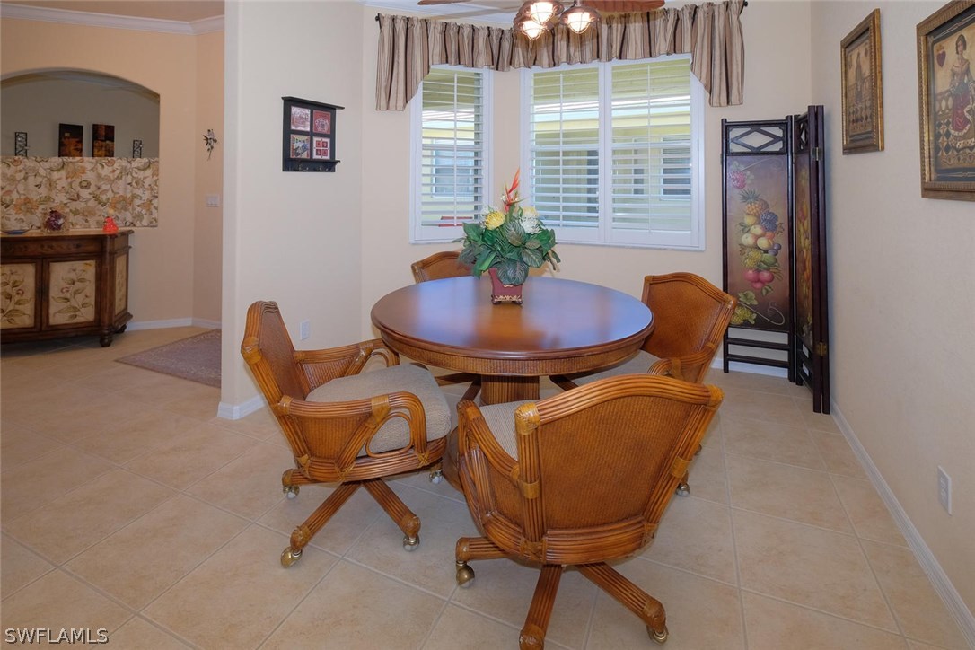 4664 Fairloop Run Lehigh Acres, FL 33973 - Photo 10 of 24 a view of a dining room with furniture and window