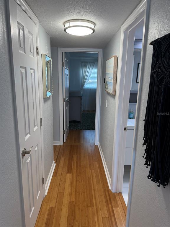 1868 Shore Drive South, Unit 608 South Pasadena, FL 33707 - Photo 17 of 36 a view of a hallway with wooden floor and staircase