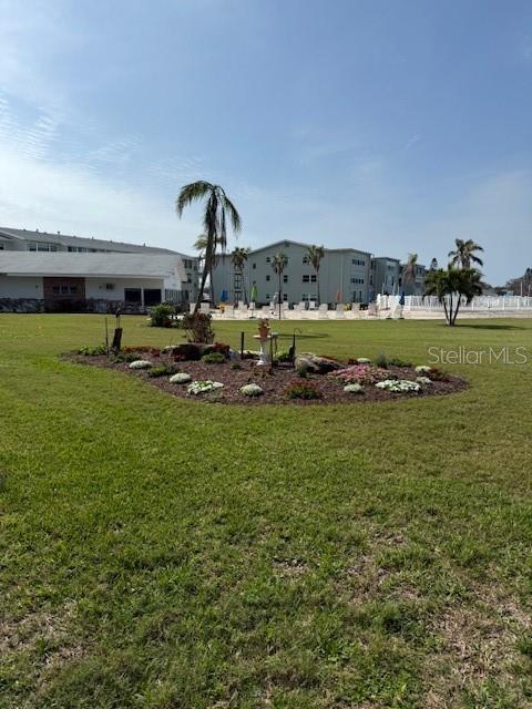 1868 Shore Drive South, Unit 608 South Pasadena, FL 33707 - Photo 23 of 36 a view of a garden with lawn chairs
