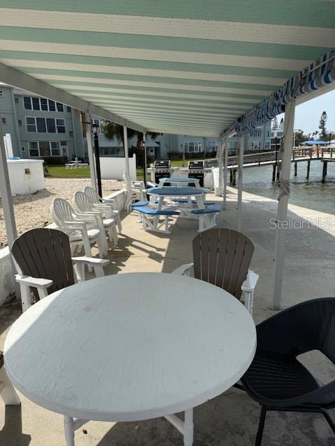 1868 Shore Drive South, Unit 608 South Pasadena, FL 33707 - Photo 26 of 36 a roof deck with table and chairs
