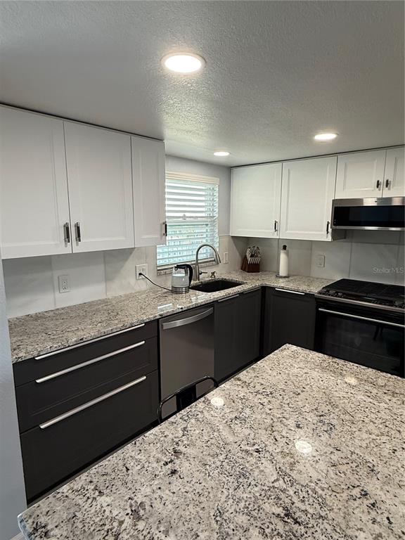 1868 Shore Drive South, Unit 608 South Pasadena, FL 33707 - Photo 5 of 36 a kitchen with a sink stove and cabinets