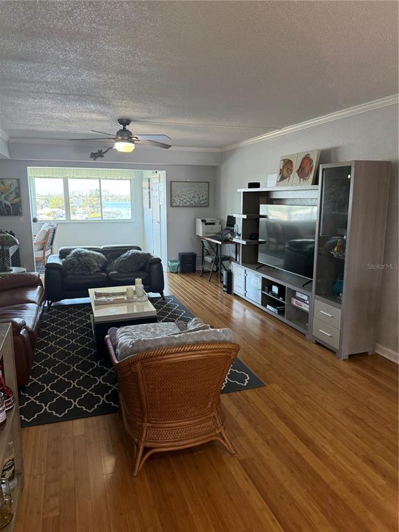 1868 Shore Drive South, Unit 608 South Pasadena, FL 33707 - Photo 8 of 36 a living room with furniture and a flat screen tv