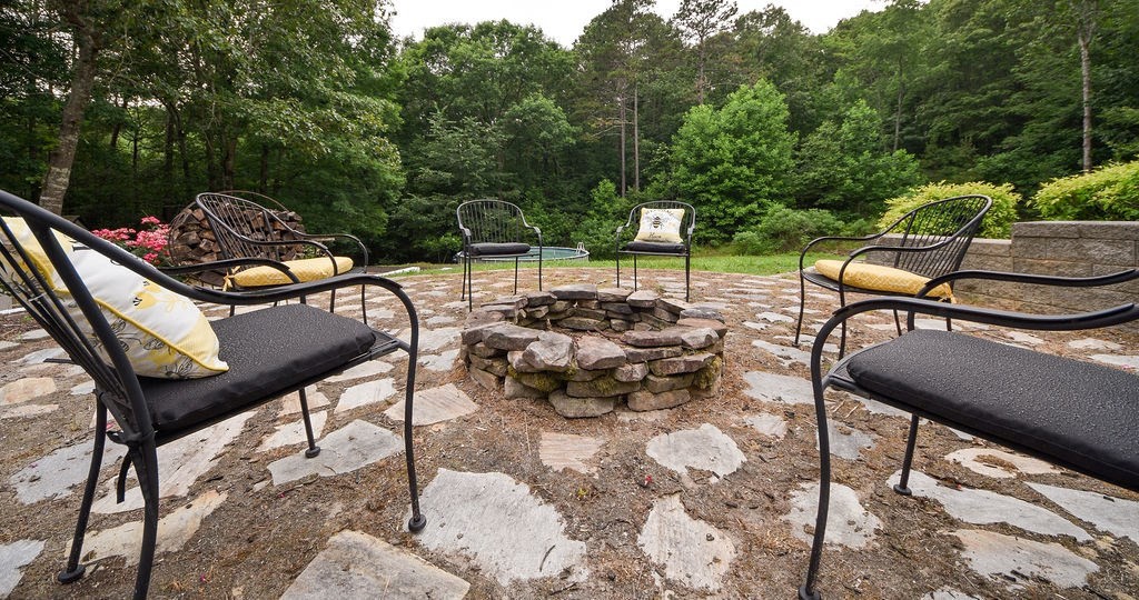 619 Eads Bluff Road Northwest Georgetown, TN 37336 - Photo 54 of 67 a view of a patio with table and chairs and couches with wooden fence