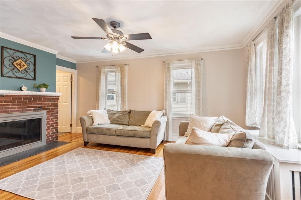 3 Joyce Road Waltham, MA 02453 - Photo 8 of 28 a living room with furniture and a fireplace
