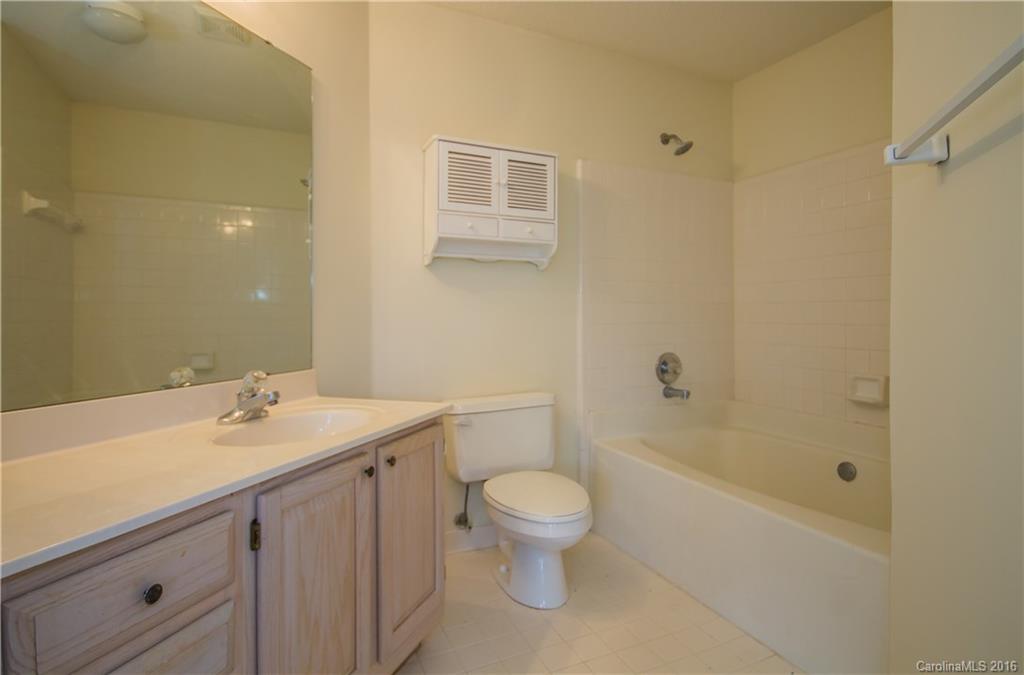 1129 Torrence Circle, Unit 1129 Davidson, NC 28036 - Photo 12 of 20 a bathroom with a sink a toilet and shower