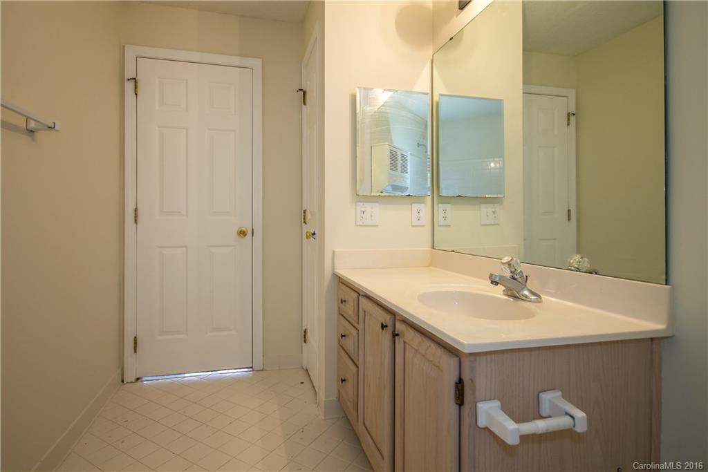 1129 Torrence Circle, Unit 1129 Davidson, NC 28036 - Photo 13 of 20 a bathroom with a sink and a mirror