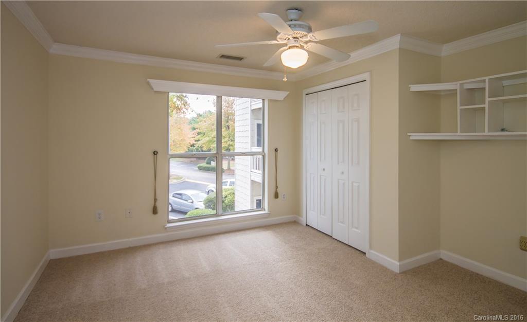 1129 Torrence Circle, Unit 1129 Davidson, NC 28036 - Photo 14 of 20 an empty room with windows and fan