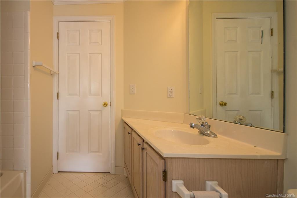 1129 Torrence Circle, Unit 1129 Davidson, NC 28036 - Photo 18 of 20 a bathroom with a sink a mirror and a shower
