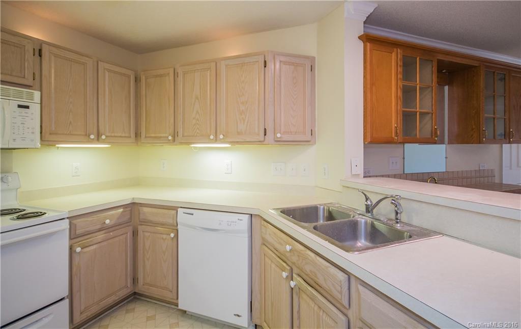 1129 Torrence Circle, Unit 1129 Davidson, NC 28036 - Photo 7 of 20 a kitchen with sink cabinets and utility