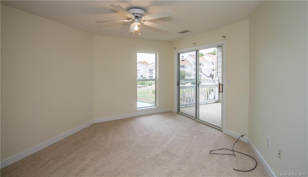1129 Torrence Circle, Unit 1129 Davidson, NC 28036 - Photo 9 of 20 a view of room with a ceiling fan and window