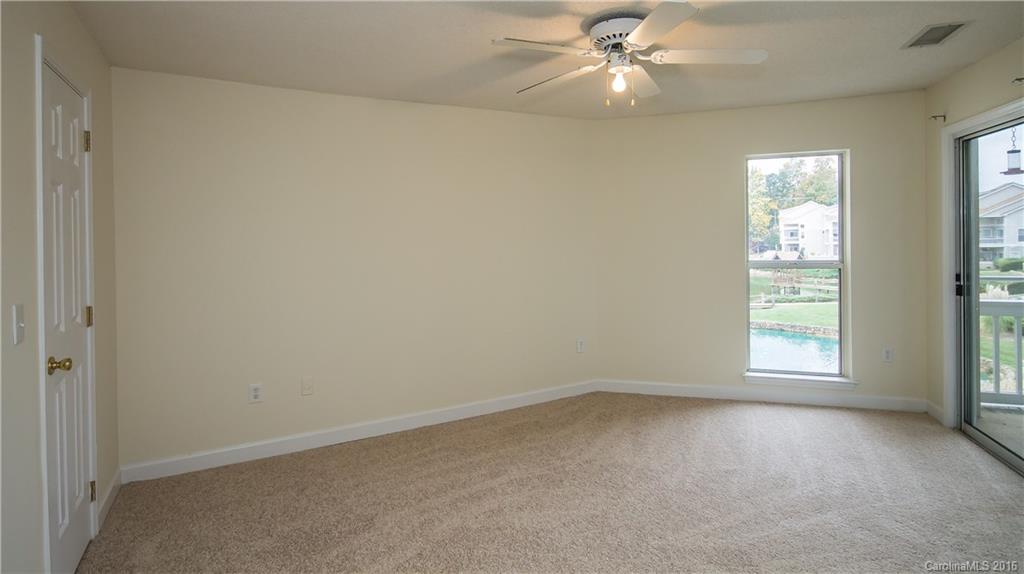 1129 Torrence Circle, Unit 1129 Davidson, NC 28036 - Photo 10 of 20 an empty room with a window and a fan