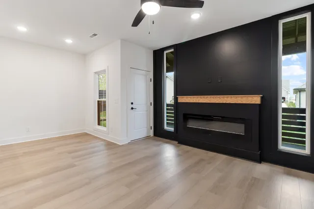 a view of an empty room with a fireplace and a window