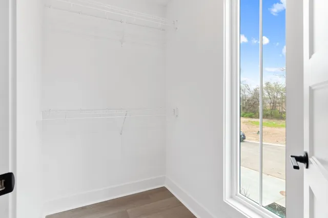 a view of an empty room and wooden floor