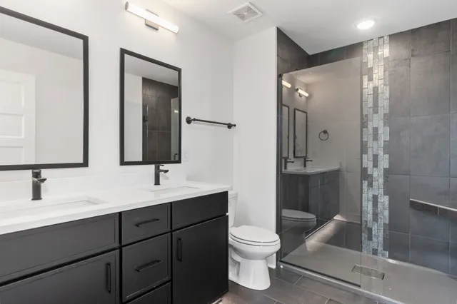 a bathroom with a sink toilet and shower
