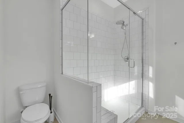 a white toilet sitting next to a bathroom