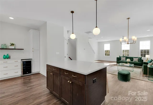 a kitchen with a stove a refrigerator a sink dishwasher with wooden floor and cabinets