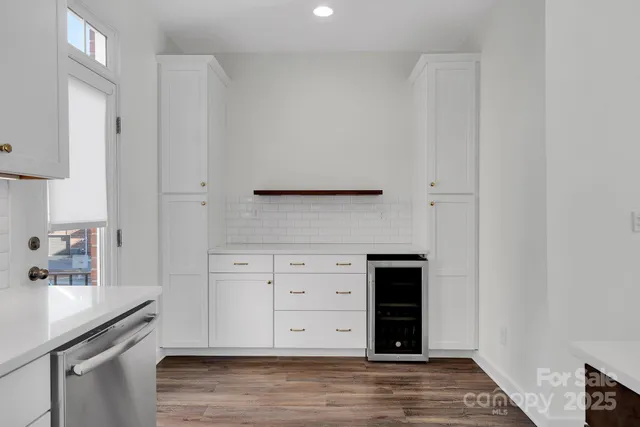 a view of a kitchen with wooden floor