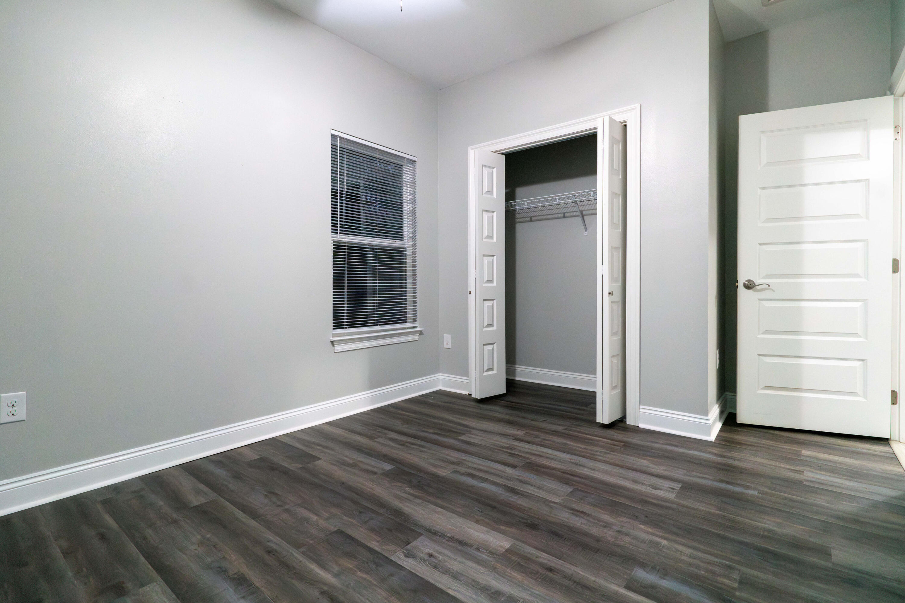 2243 Wind Trace Road North Navarre, FL 32566 - Photo 25 of 34 a view of an empty room with a window and wooden floor