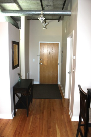 933 West Van Buren Street, Unit 321 Chicago, IL 60607 - Photo 3 of 18 a view of a livingroom with furniture and hardwood floor