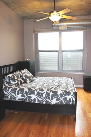 933 West Van Buren Street, Unit 321 Chicago, IL 60607 - Photo 8 of 18 a bedroom with a bed and a window
