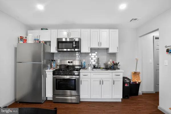 a kitchen with stainless steel appliances a refrigerator stove and sink