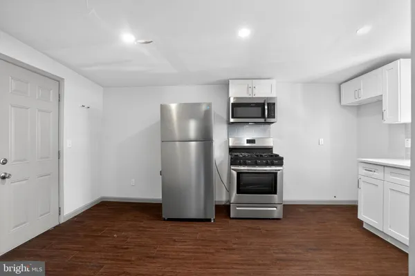a kitchen with a refrigerator and a stove
