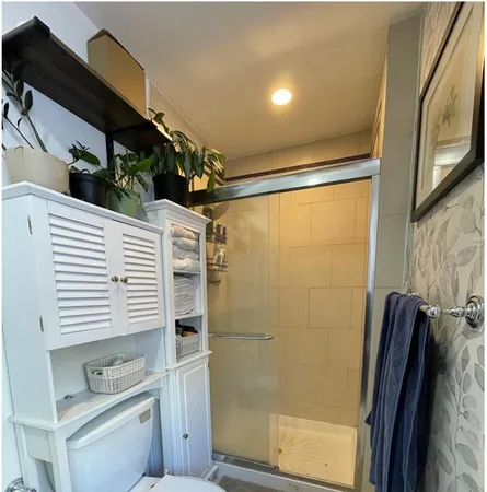 a bathroom with a shower and a sink