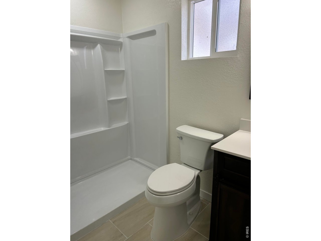 809 Warren Street Weldona, CO 80653 - Photo 11 of 19 a white toilet sitting next to a bathroom sink and vanity