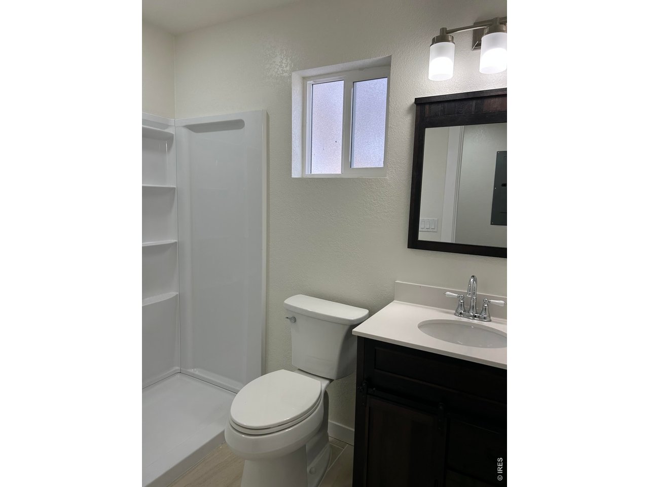 809 Warren Street Weldona, CO 80653 - Photo 12 of 19 a bathroom with a toilet sink and mirror