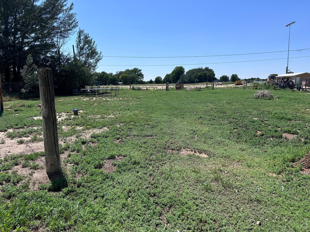 809 Warren Street Weldona, CO 80653 - Photo 15 of 19 a view of a garden with a tree