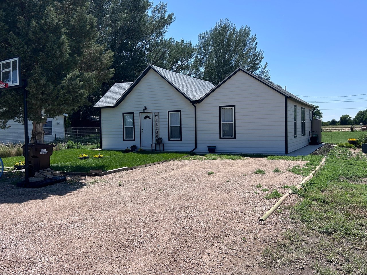809 Warren Street Weldona, CO 80653 - Photo 16 of 19 a view of a house with a yard