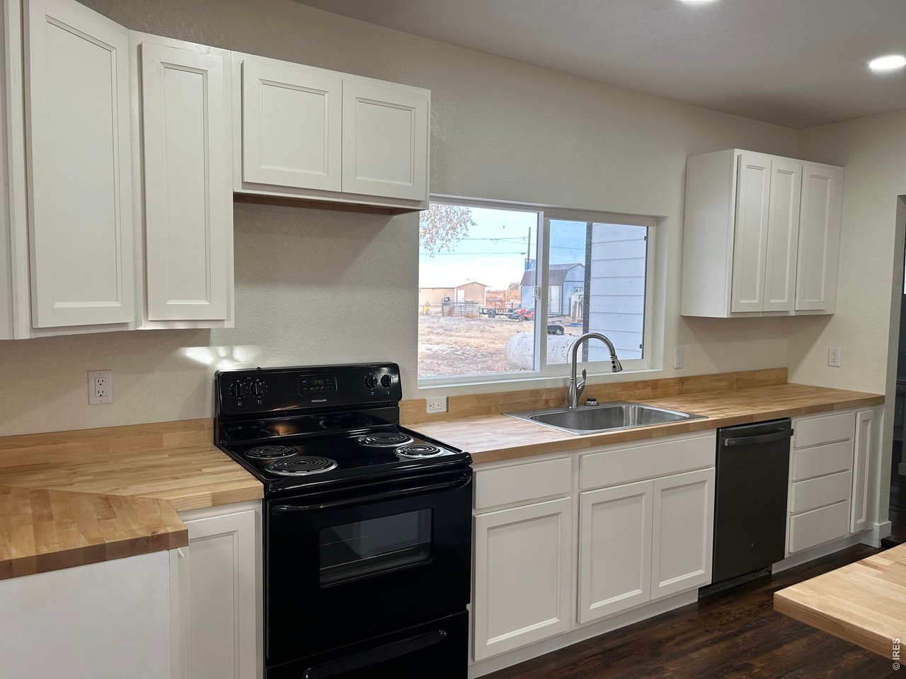 809 Warren Street Weldona, CO 80653 - Photo 4 of 19 a kitchen with granite countertop cabinets sink and window