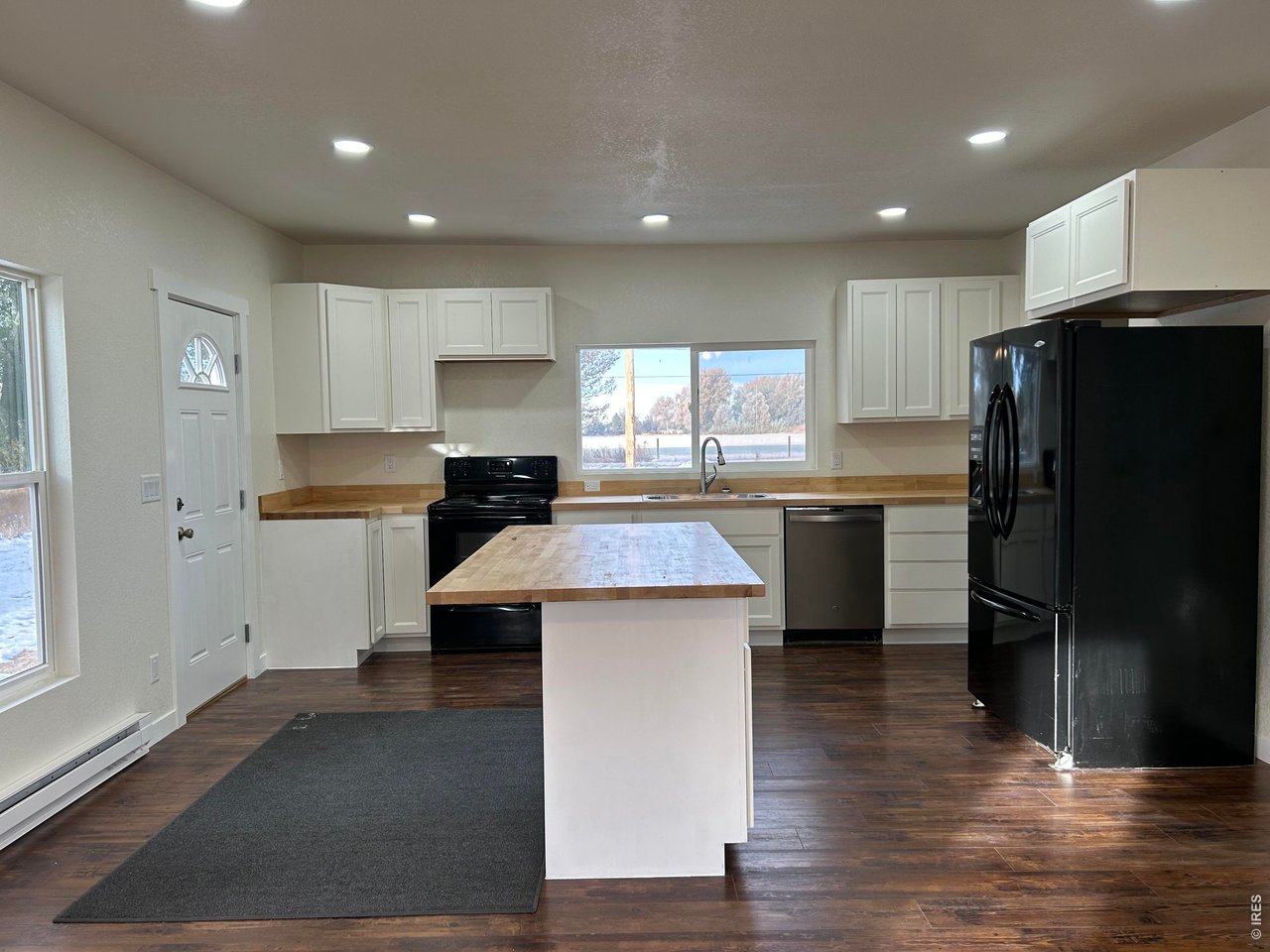 809 Warren Street Weldona, CO 80653 - Photo 6 of 19 a kitchen with a refrigerator and a sink