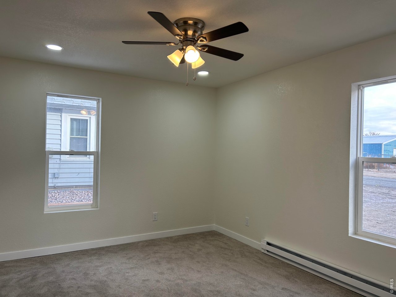809 Warren Street Weldona, CO 80653 - Photo 8 of 19 an empty room with windows and fan