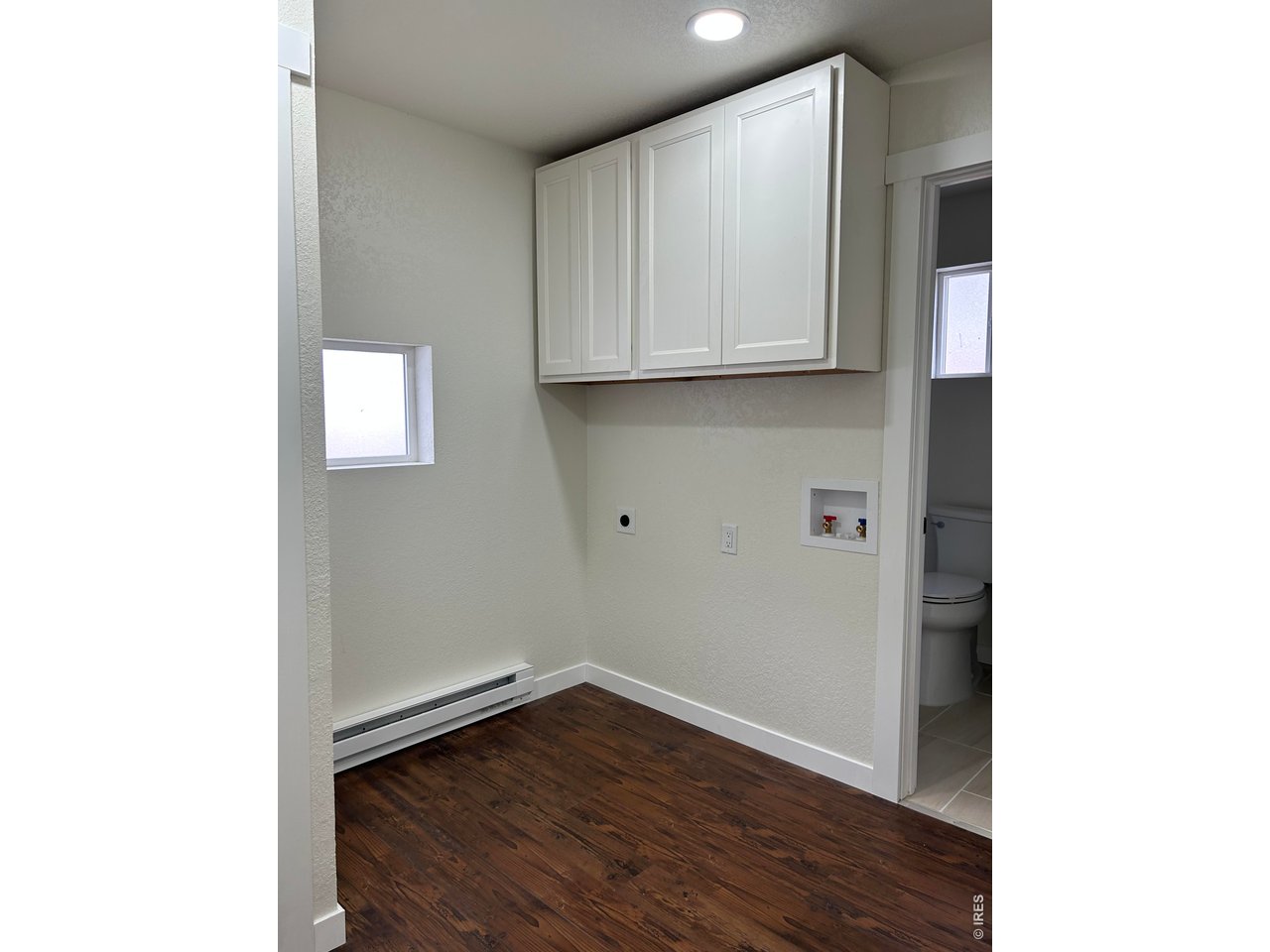809 Warren Street Weldona, CO 80653 - Photo 10 of 19 a view of an empty room with wooden floor