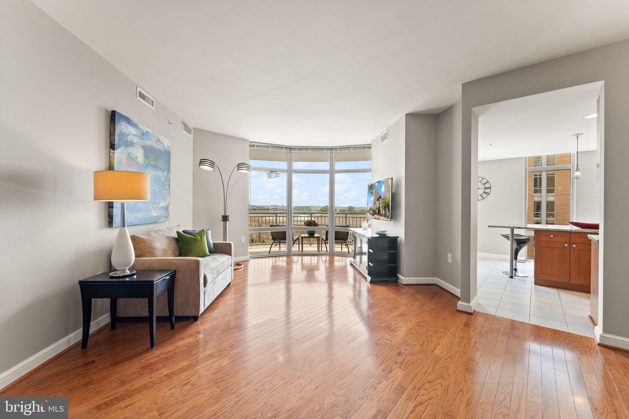 11990 Market Street, Unit 701 Reston, VA 20190 - Photo 15 of 93 a living room with furniture and a table