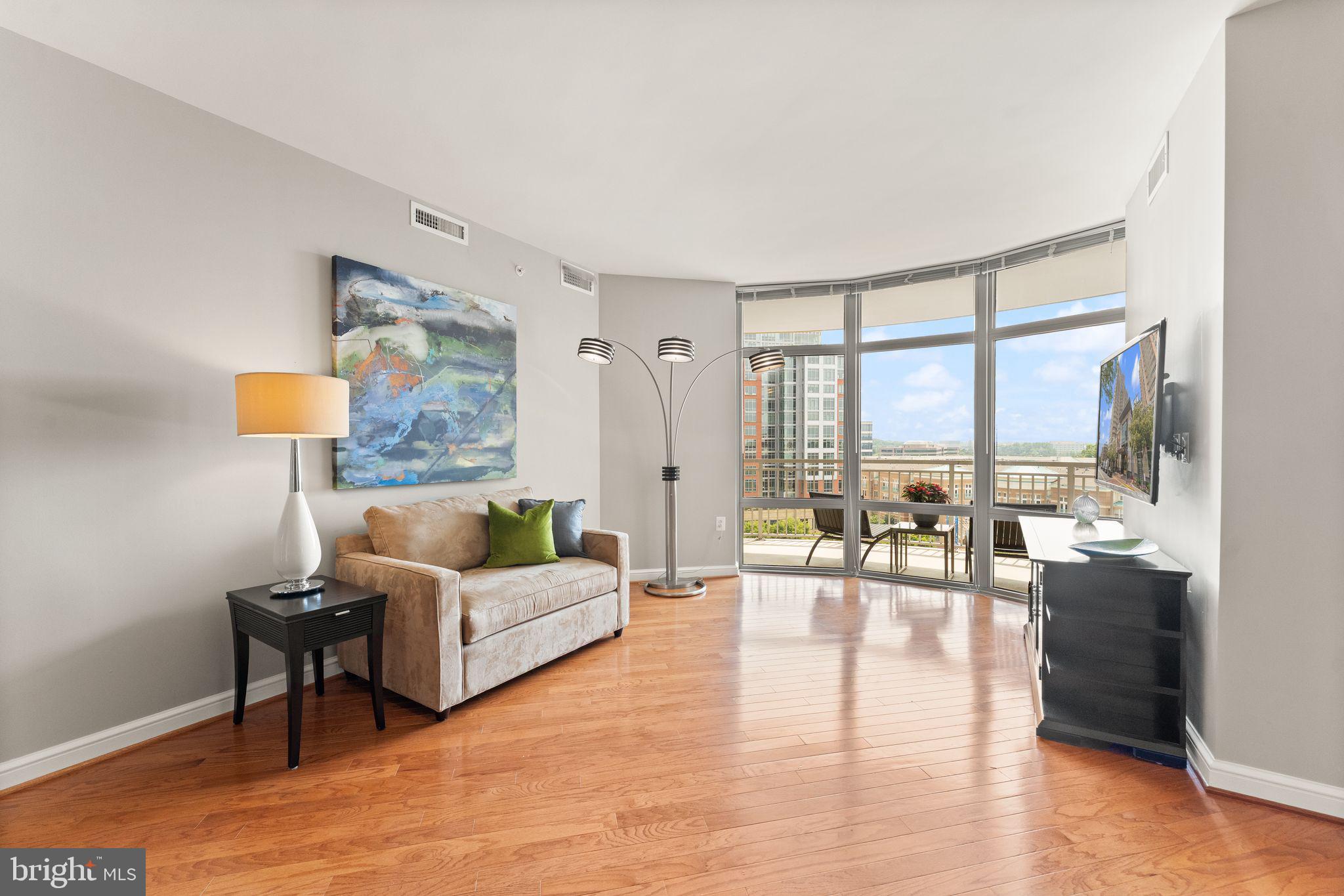11990 Market Street, Unit 701 Reston, VA 20190 - Photo 16 of 93 a living room with furniture and a large window