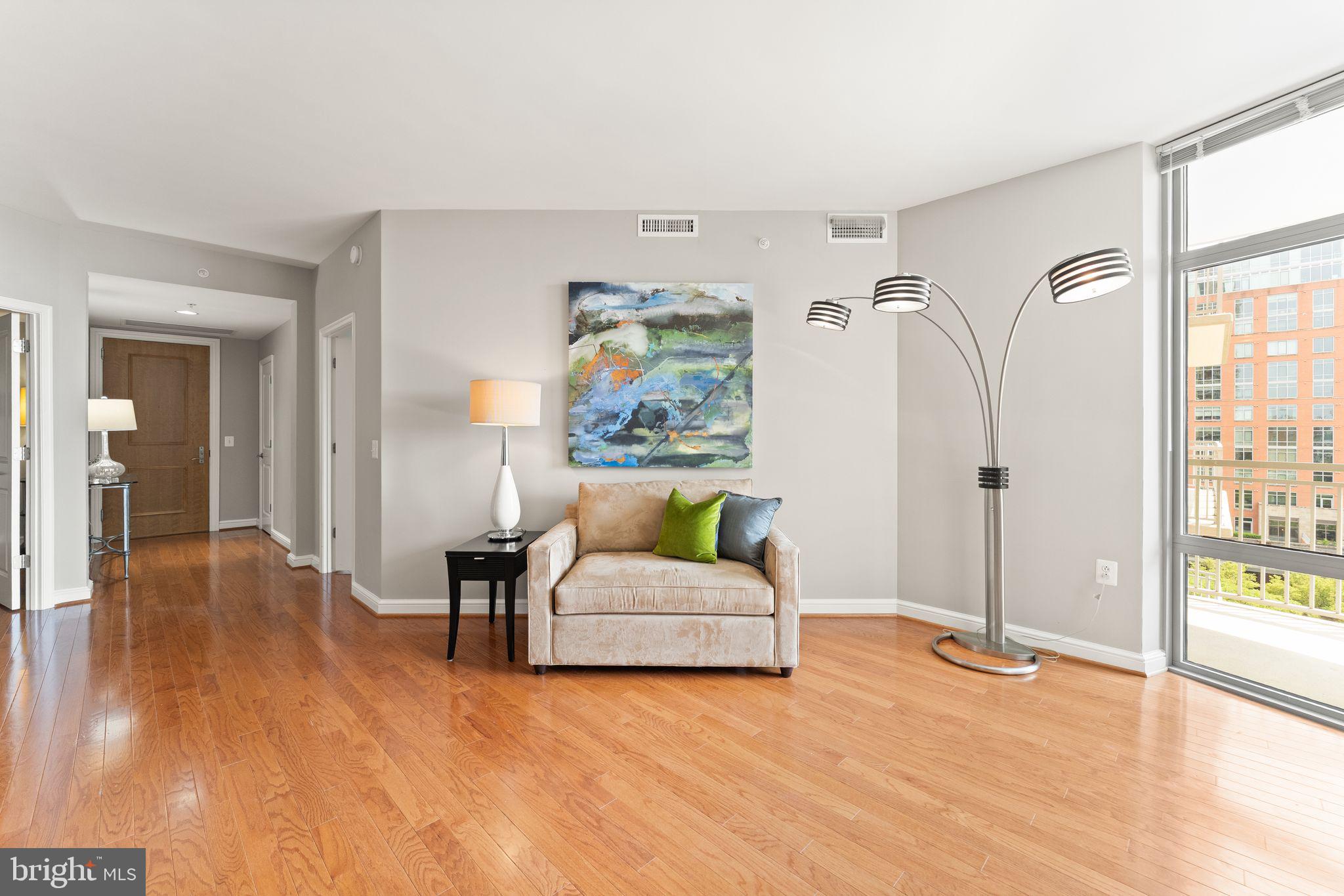 11990 Market Street, Unit 701 Reston, VA 20190 - Photo 17 of 93 a living room with furniture and a wooden floor