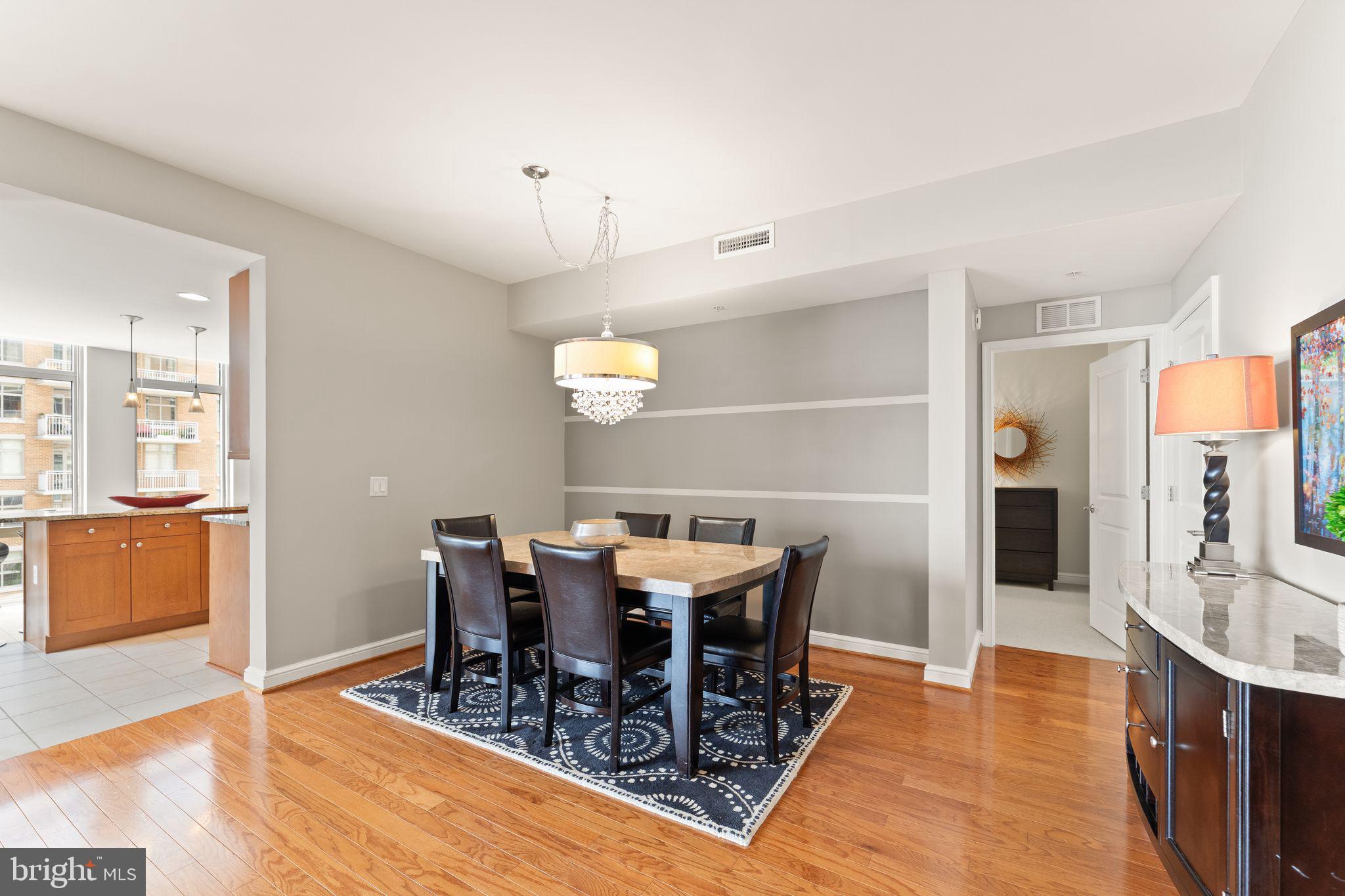 11990 Market Street, Unit 701 Reston, VA 20190 - Photo 20 of 93 a view of a dining room with furniture and wooden floor