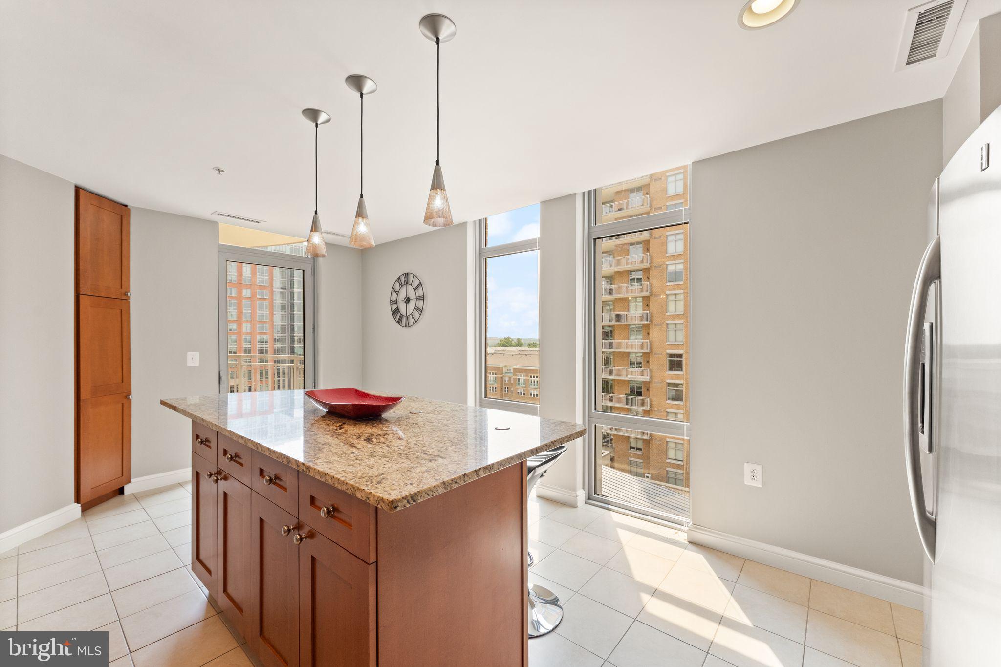 11990 Market Street, Unit 701 Reston, VA 20190 - Photo 30 of 93 a kitchen with stainless steel appliances granite countertop a sink and a refrigerator