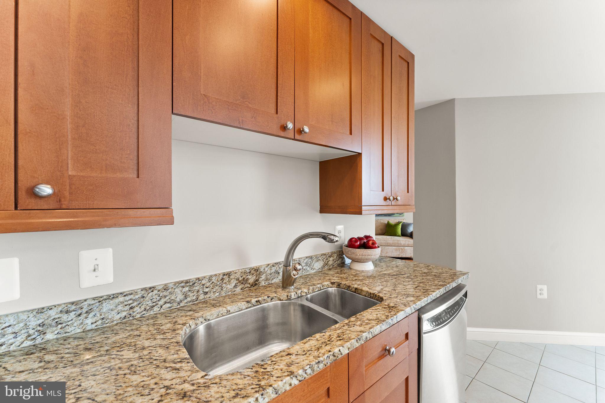 11990 Market Street, Unit 701 Reston, VA 20190 - Photo 32 of 93 a kitchen with granite countertop a sink and a stove