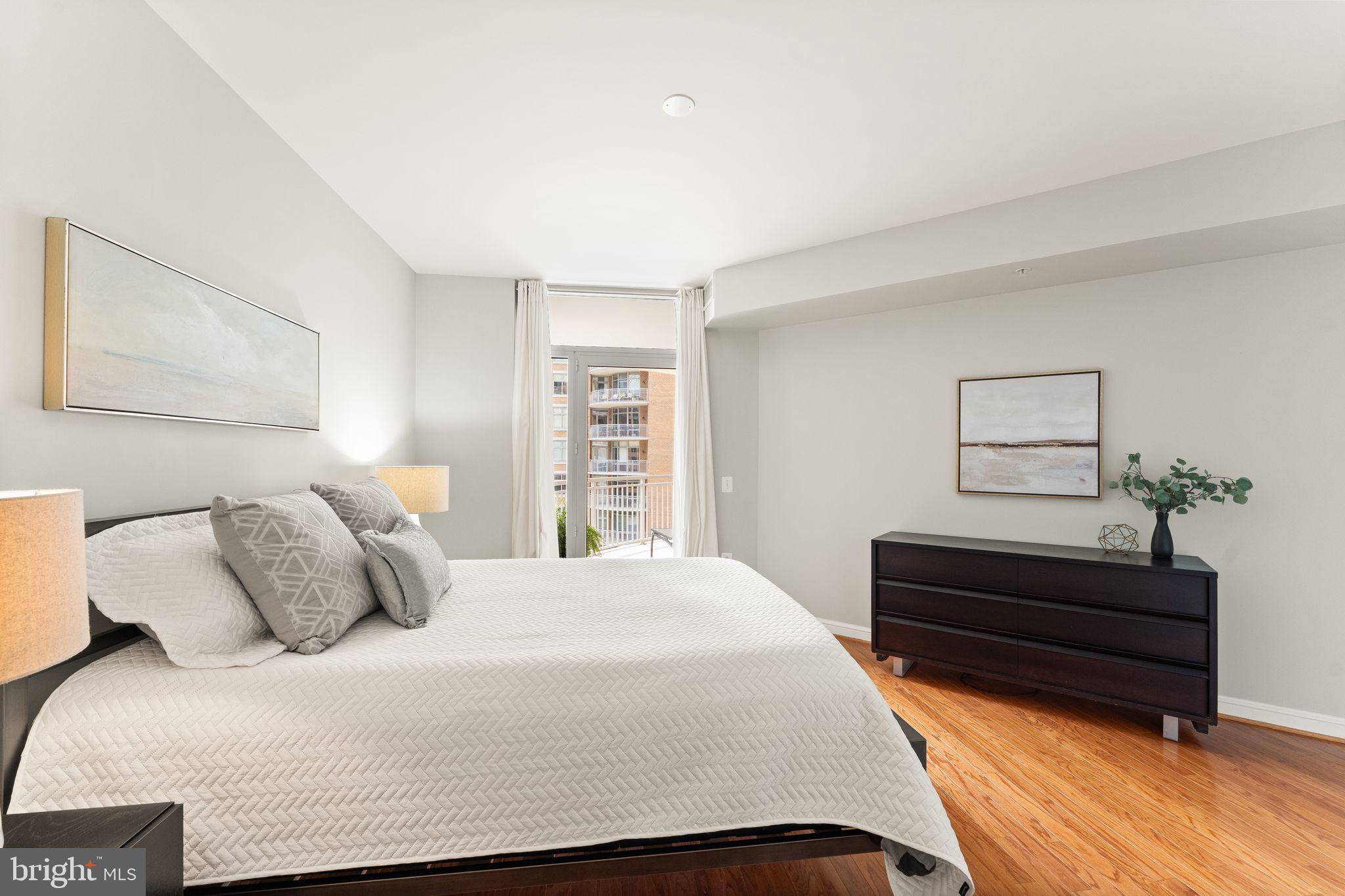 11990 Market Street, Unit 701 Reston, VA 20190 - Photo 36 of 93 a bedroom with a bed window and a night stand