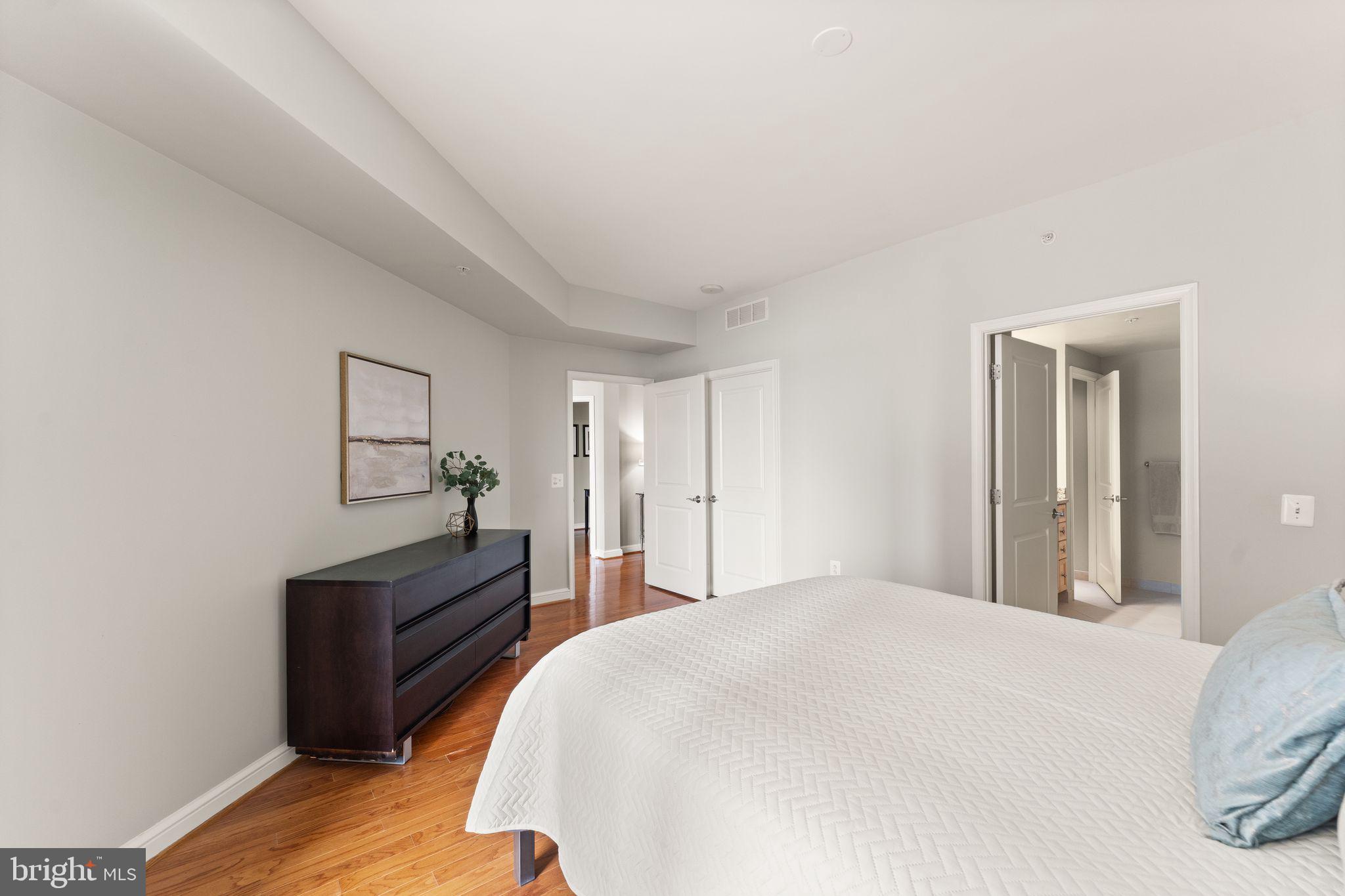 11990 Market Street, Unit 701 Reston, VA 20190 - Photo 37 of 93 a bedroom with a bed and a potted plant