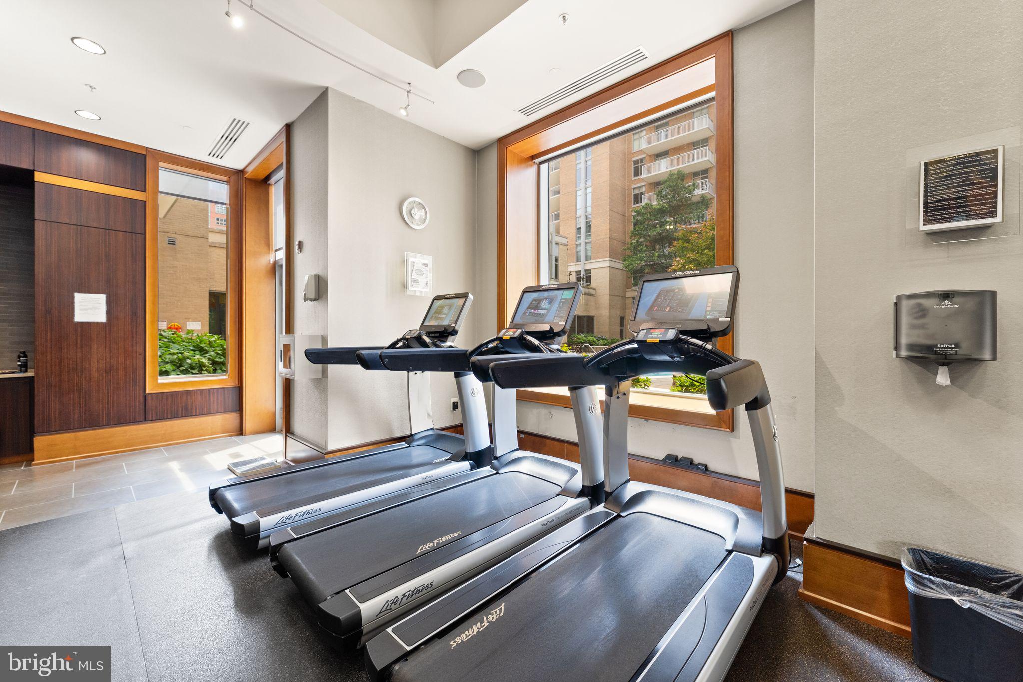 11990 Market Street, Unit 701 Reston, VA 20190 - Photo 51 of 93 a room with gym equipment and a large window