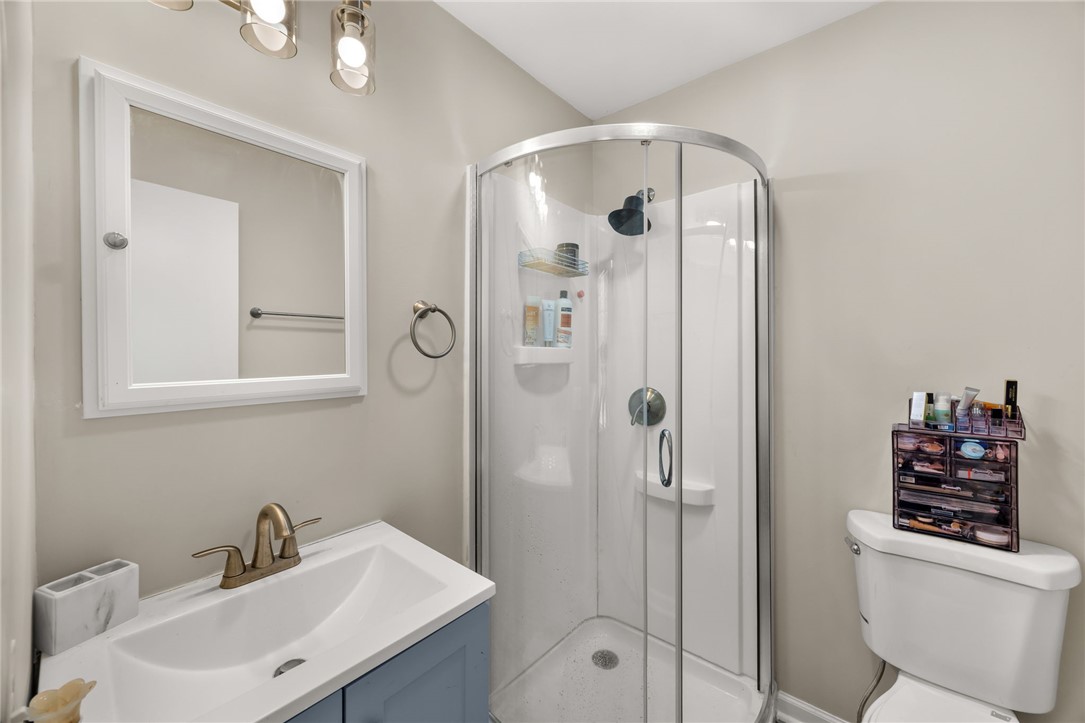 309 East Hampton Avenue Honea Path, SC 29654 - Photo 19 of 23 This bright bathroom features a vanity, shower, and toilet, offering essential comfort and functionality.