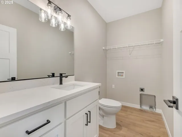 a bathroom with a sink a toilet and a mirror