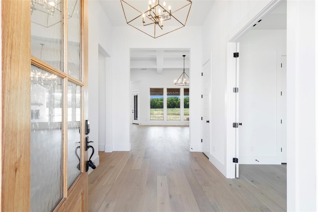 800 Vest Lane Pilot Point, TX 76258 - Photo 5 of 15 a view of a hallway with wooden floor and a window