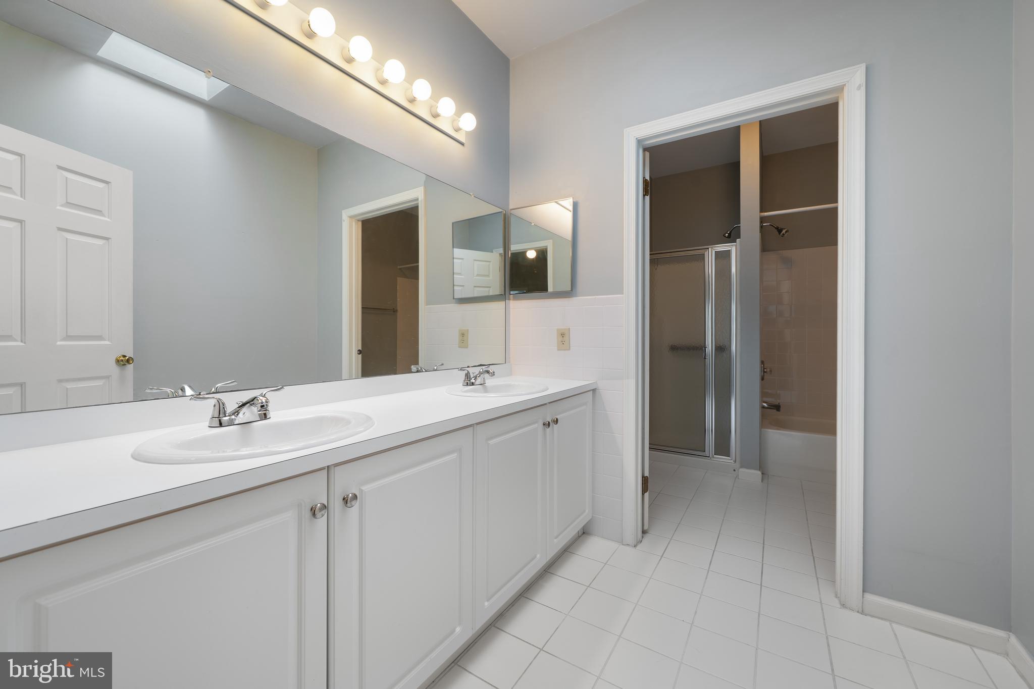 16 Newport Road Manahawkin, NJ 08050 - Photo 18 of 36 a spacious bathroom with a double vanity sink and a mirror