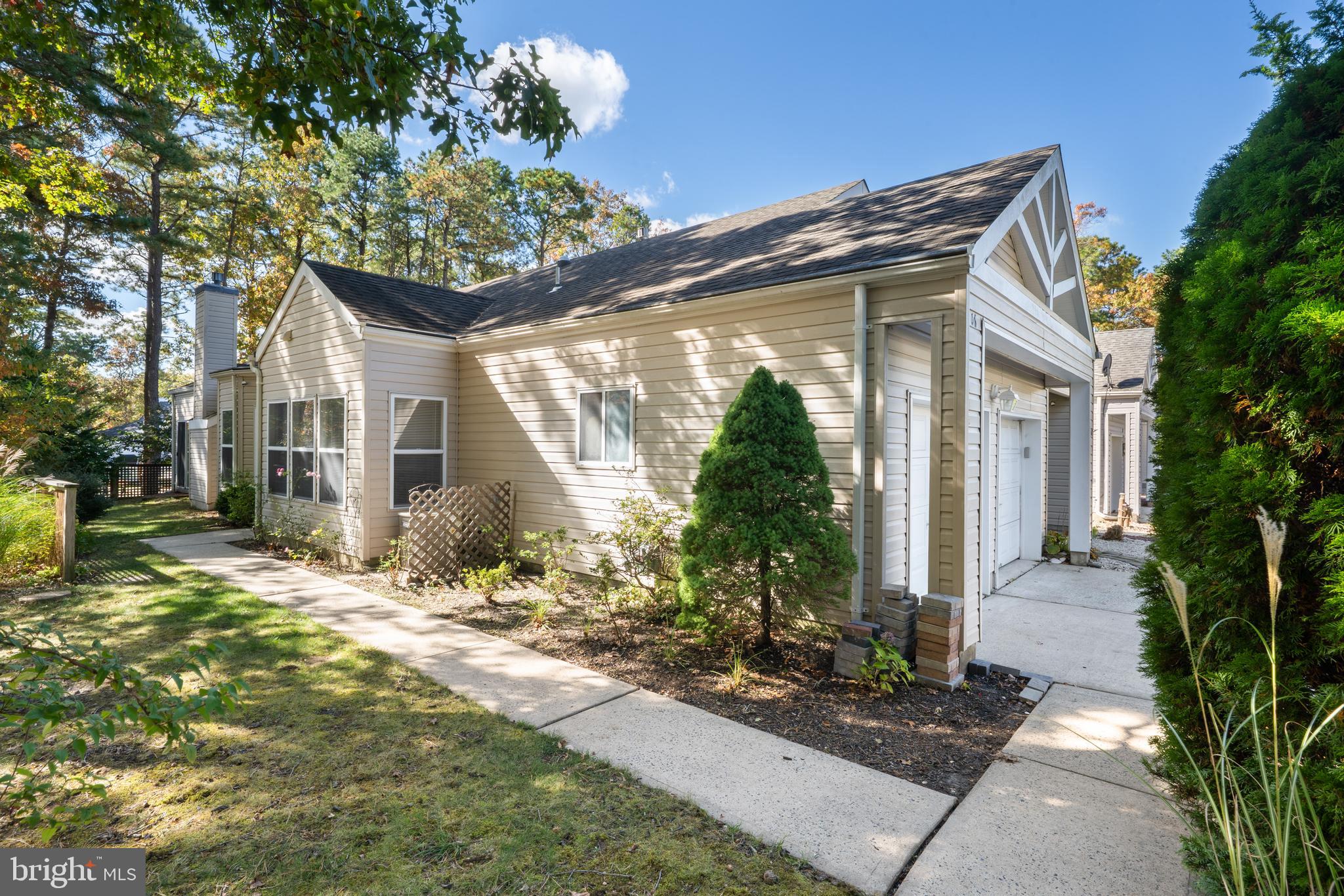16 Newport Road Manahawkin, NJ 08050 - Photo 26 of 36 a front view of a house with garden