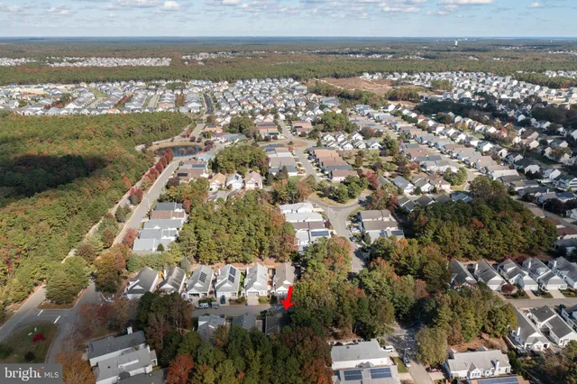 an aerial view of residential houses with outdoor space and lake view